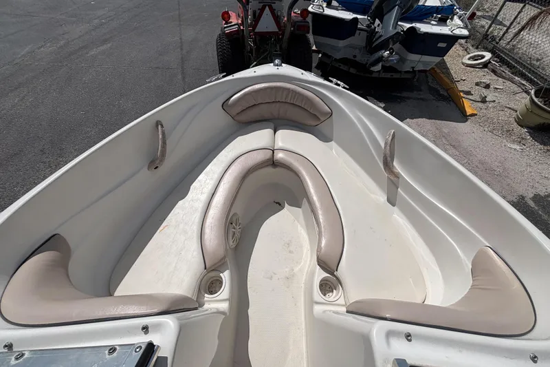 Slide: The Image of 2002 Sea Ray 176 Bow Rider boat interior with beige seating and cup holders. - 22