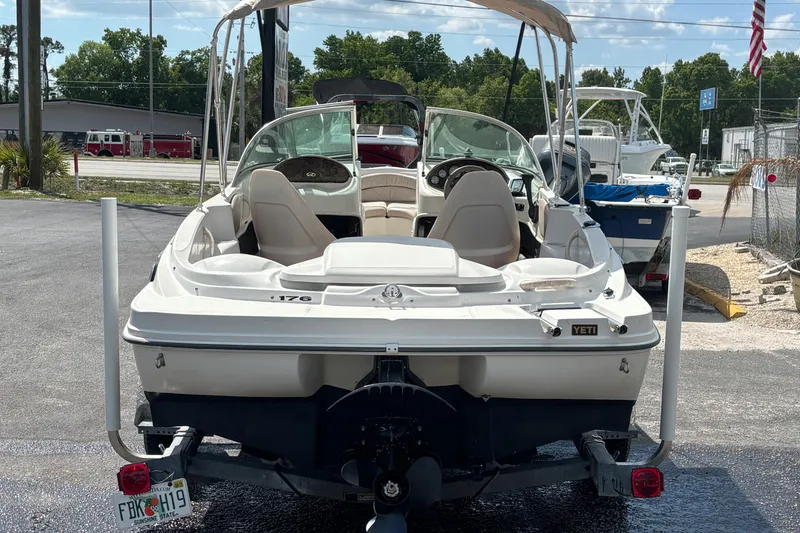 Slide: The Image of 2002 Sea Ray 176 Bow Rider boat on trailer, parked outdoors under sunny skies. - 3
