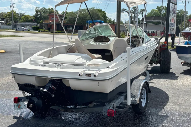 Slide: The Image of 2002 Sea Ray 176 Bow Rider boat on trailer, parked outdoors in a lot. - 4