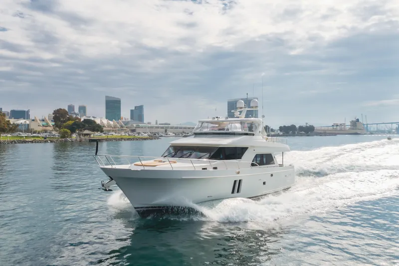 The Image of 2015 Ocean Alexander 72 Pilothouse yacht cruising near city skyline. - 1