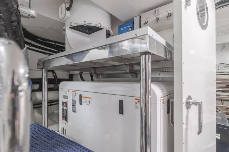 Slide: The Image of Engine room of 2015 Ocean Alexander 72 Pilothouse yacht, featuring modern equipment and controls. - 12