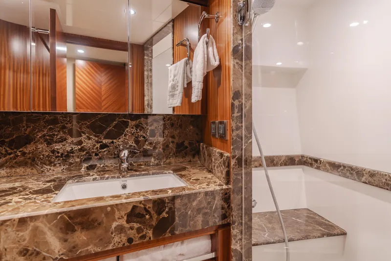 Slide: The Image of Luxurious bathroom in 2015 Ocean Alexander 72 Pilothouse yacht with marble countertop and modern fixtures. - 17