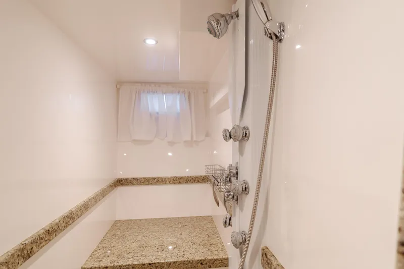 Slide: The Image of Luxurious shower area in 2015 Ocean Alexander 72 Pilothouse yacht with granite bench. - 24