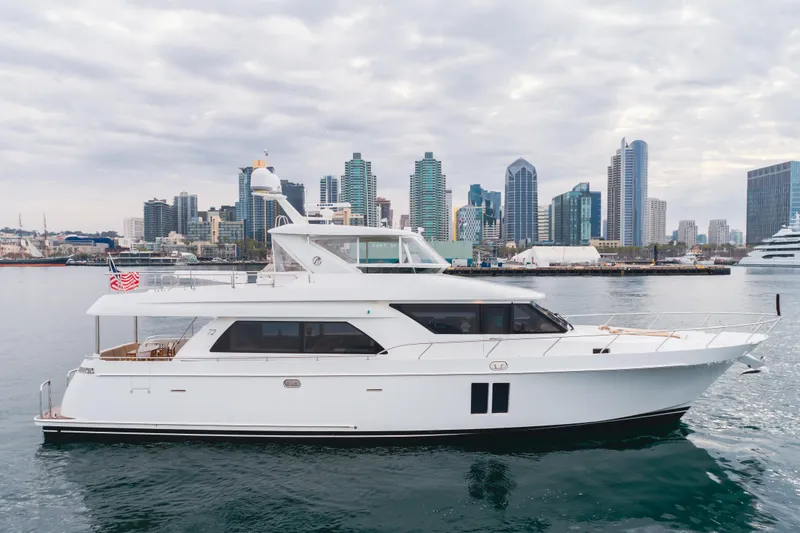 Slide: The Image of 2015 Ocean Alexander 72 Pilothouse yacht in urban harbor with city skyline backdrop. - 3