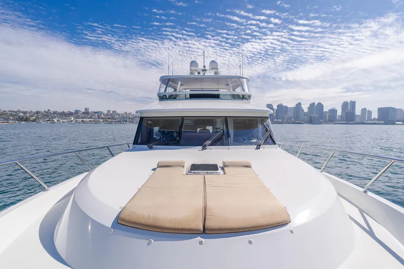 Slide: The Image of 2015 Ocean Alexander 72 Pilothouse yacht cruising near city skyline under blue sky. - 33