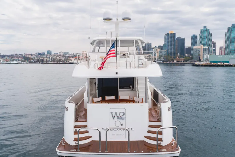 Slide: The Image of 2015 Ocean Alexander 72 Pilothouse yacht docked with city skyline backdrop. - 4
