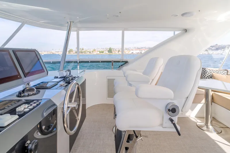 Slide: The Image of Pilothouse interior of 2015 Ocean Alexander 72, featuring helm controls and white seating. - 46