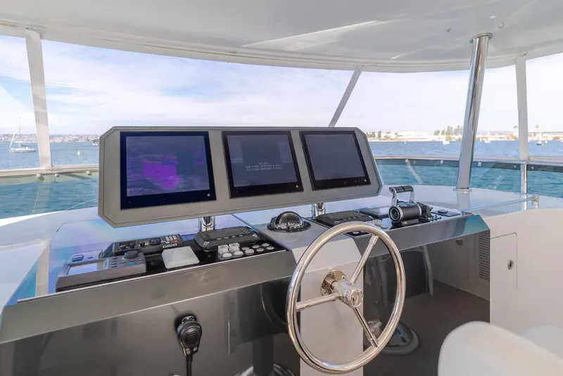 Slide: The Image of Pilothouse of 2015 Ocean Alexander 72, featuring modern navigation equipment and steering wheel. - 47