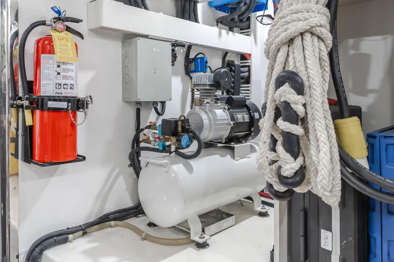 Slide: The Image of Engine room of 2015 Ocean Alexander 72 Pilothouse with equipment and fire extinguisher. - 9