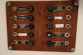 Slide: The Image of 1977 C&C 29 sailboat control panel with labeled switches for navigation, instruments, and lights. - 11