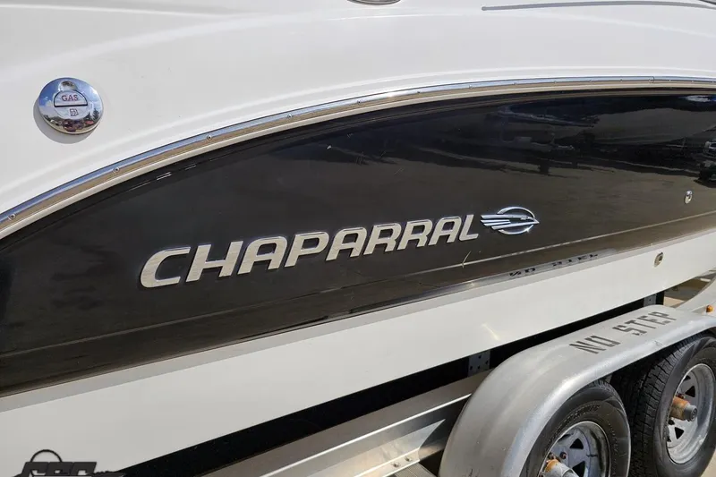 Slide: The Image of 2007 Chaparral 256 SSi boat side view with logo and trailer. - 11