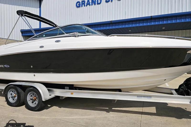 Slide: The Image of 2007 Chaparral 256 SSi boat on trailer, parked outside a building. - 12