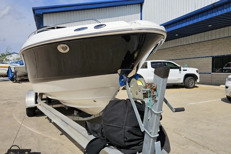 Slide: The Image of 2007 Chaparral 256 SSi boat on trailer, parked outside a building. - 14