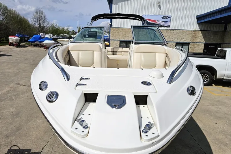 Slide: The Image of 2007 Chaparral 256 SSi boat with open bow seating, parked outdoors. - 15