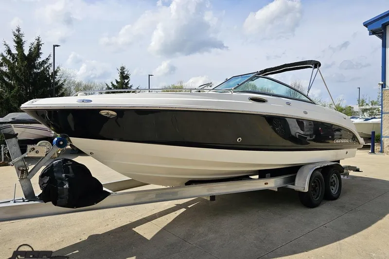 Slide: The Image of 2007 Chaparral 256 SSi boat on trailer, black and white design, parked outdoors. - 18