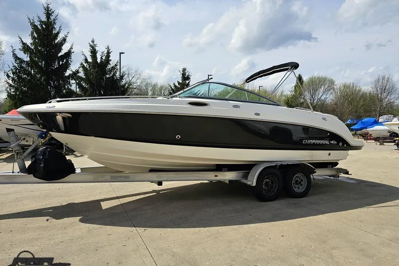 Slide: The Image of 2007 Chaparral 256 SSi boat on trailer, black and white design, parked outdoors. - 19
