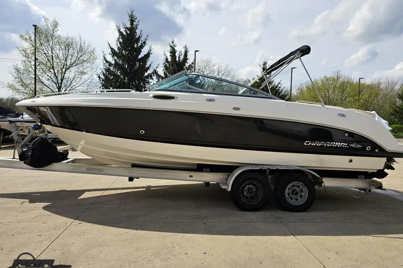 Slide: The Image of 2007 Chaparral 256 SSi boat on trailer, black and white design, parked outdoors. - 20