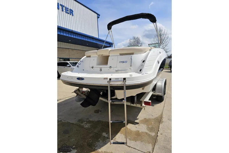 Slide: The Image of 2007 Chaparral 256 SSi boat rear view with ladder, parked outdoors. - 26