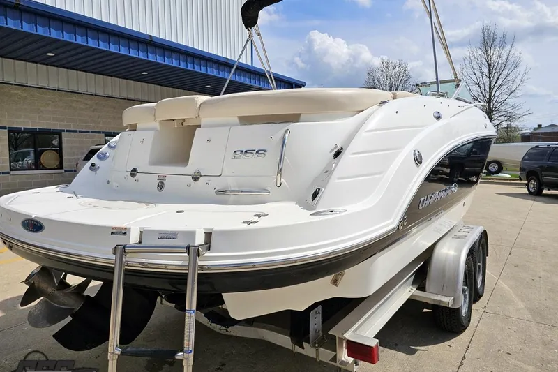 Slide: The Image of 2007 Chaparral 256 SSi boat on trailer, parked outside a building. - 27