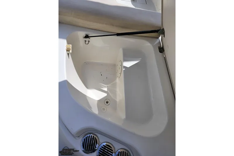 Slide: The Image of 2007 Chaparral 256 SSi boat interior storage compartment with open lid and ventilation grilles. - 32