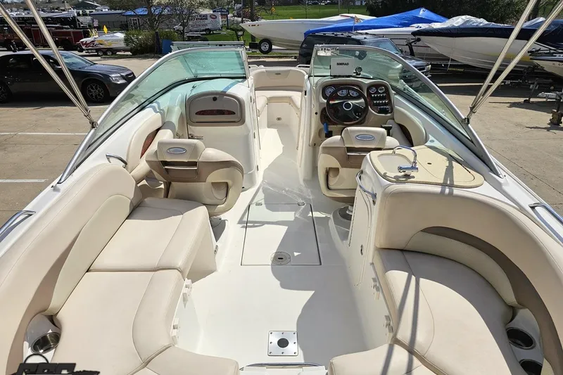 Slide: The Image of 2007 Chaparral 256 SSi boat interior with beige seating and modern dashboard. - 36