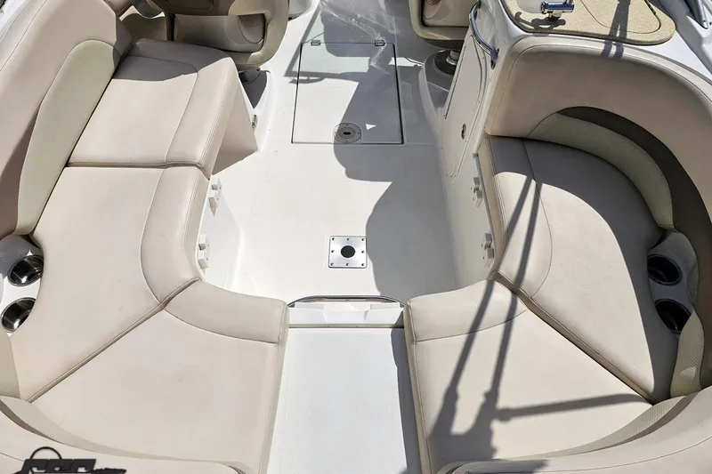 Slide: The Image of 2007 Chaparral 256 SSi boat interior with beige seating and cup holders. - 37