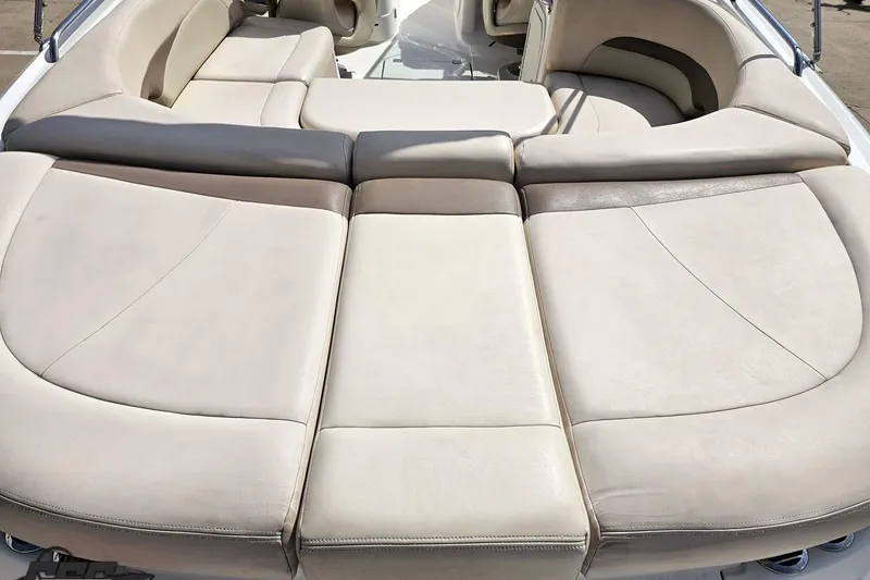 Slide: The Image of 2007 Chaparral 256 SSi boat interior with beige cushioned seating. - 39