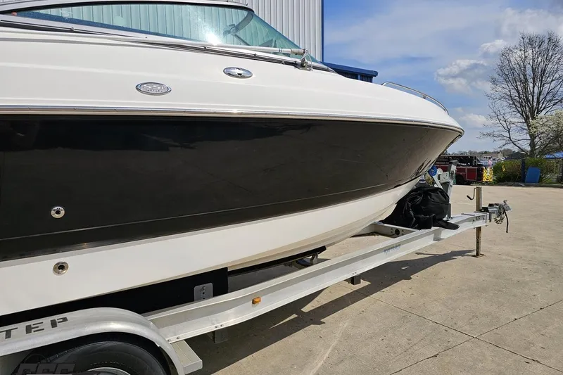 Slide: The Image of 2007 Chaparral 256 SSi boat on trailer, parked outdoors under a clear sky. - 4