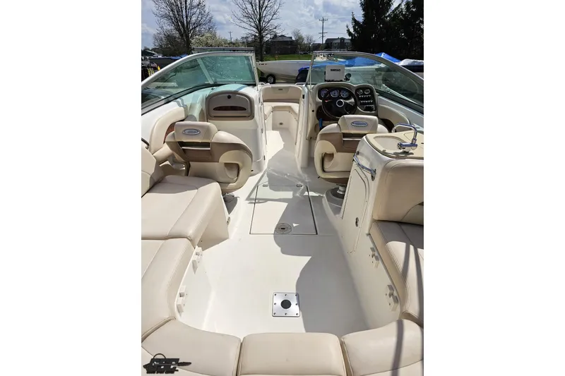 Slide: The Image of 2007 Chaparral 256 SSi boat interior with beige seating and modern dashboard controls. - 43