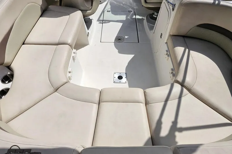 Slide: The Image of 2007 Chaparral 256 SSi boat interior with beige seating and cup holders. - 44