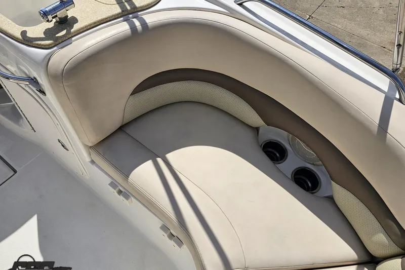 Slide: The Image of 2007 Chaparral 256 SSi boat interior with beige seating and cup holders. - 47