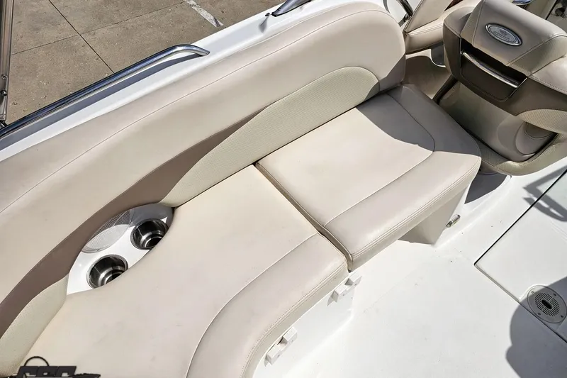 Slide: The Image of 2007 Chaparral 256 SSi boat interior with beige seating and built-in cup holders. - 48