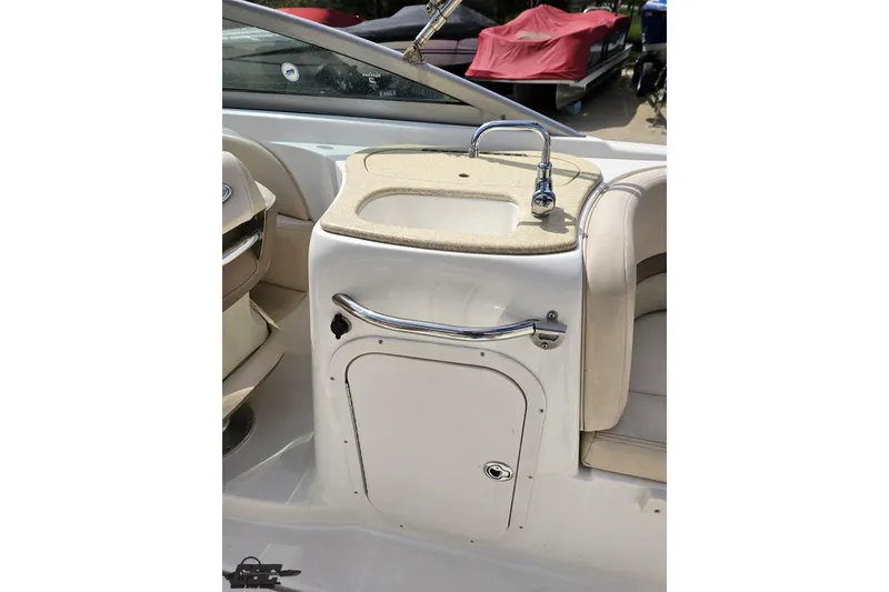 Slide: The Image of 2007 Chaparral 256 SSi boat interior with sink and storage compartment. - 50