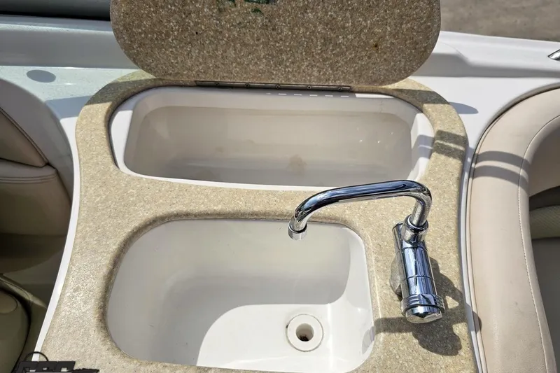 Slide: The Image of 2007 Chaparral 256 SSi boat sink with chrome faucet and beige countertop. - 51