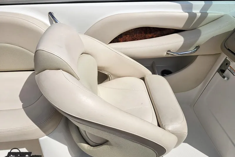 Slide: The Image of 2007 Chaparral 256 SSi boat interior with white leather seating and chrome accents. - 53