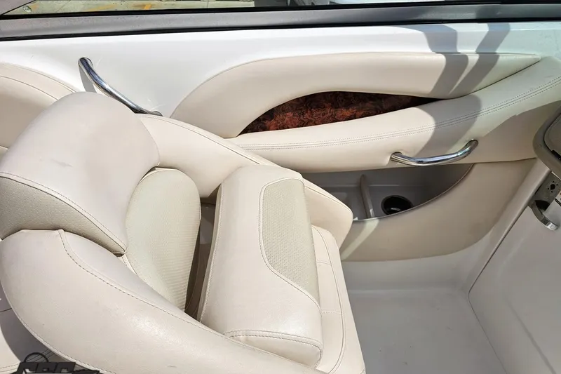 Slide: The Image of 2007 Chaparral 256 SSi boat interior with beige leather seating and chrome accents. - 54
