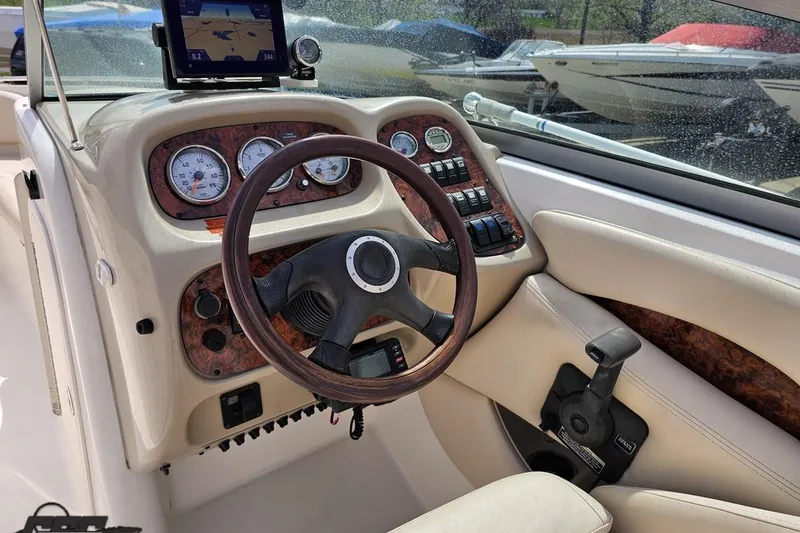 Slide: The Image of 2007 Chaparral 256 SSi boat dashboard with steering wheel and navigation system. - 56