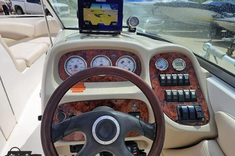 Slide: The Image of 2007 Chaparral 256 SSi boat dashboard with steering wheel, gauges, and navigation system. - 57