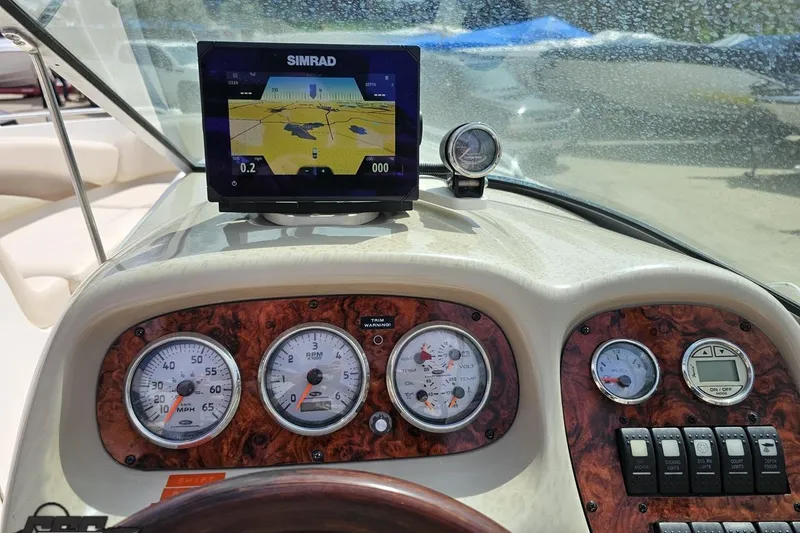 Slide: The Image of Dashboard of a 2007 Chaparral 256 SSi boat with gauges and navigation display. - 58