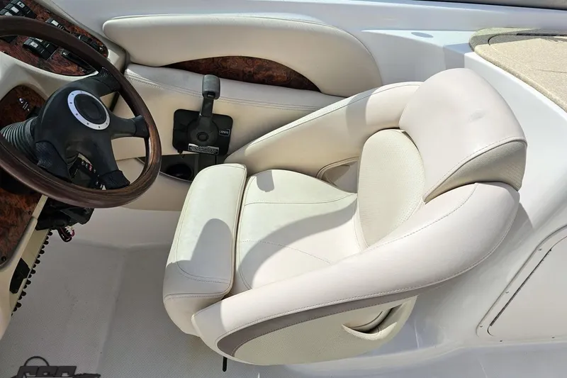 Slide: The Image of 2007 Chaparral 256 SSi boat interior with steering wheel and plush captain's seat. - 59