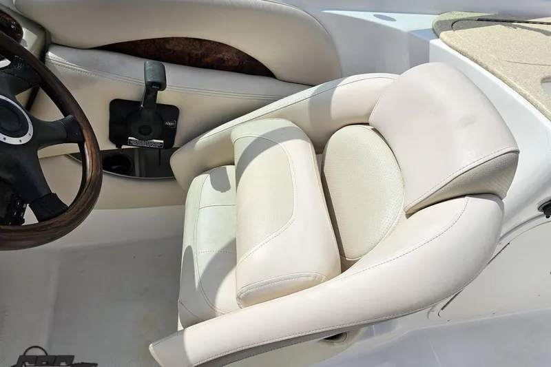 Slide: The Image of 2007 Chaparral 256 SSi boat interior with beige leather seat and steering wheel. - 60