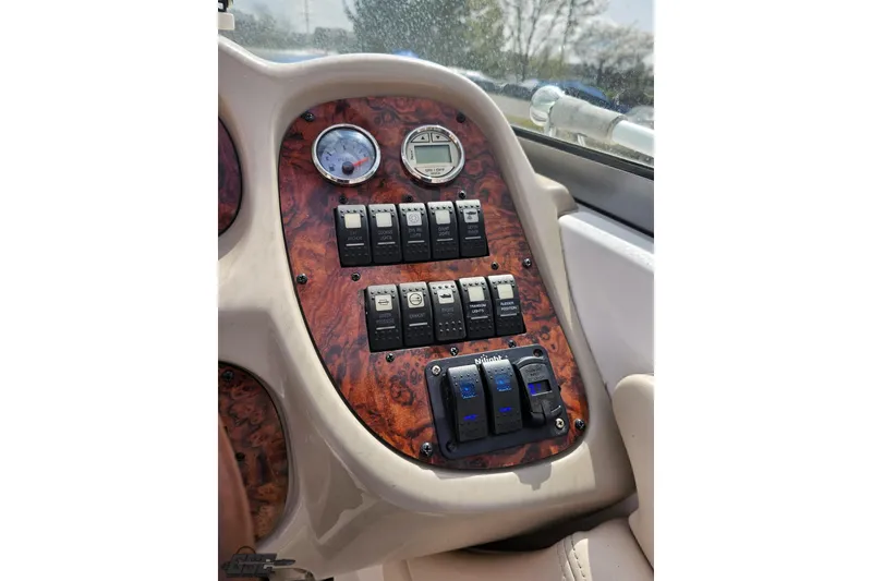 Slide: The Image of Dashboard of 2007 Chaparral 256 SSi boat with wood finish and control switches. - 61