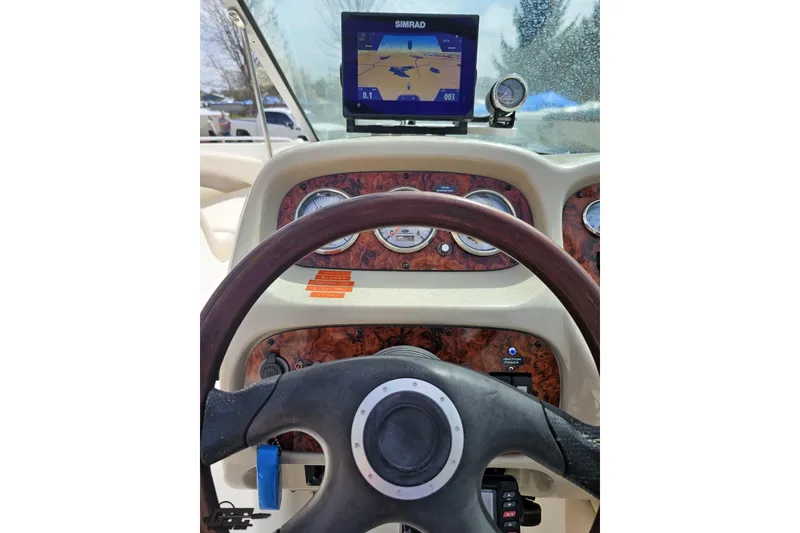 Slide: The Image of Steering wheel and dashboard of a 2007 Chaparral 256 SSi boat with navigation display. - 63