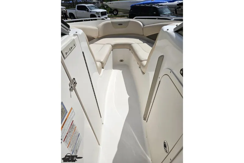 Slide: The Image of 2007 Chaparral 256 SSi boat interior with beige seating and white deck. - 65