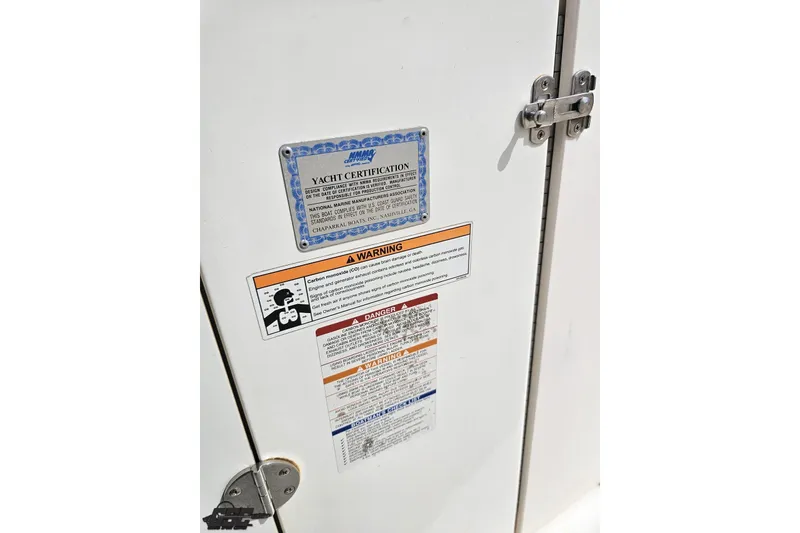 Slide: The Image of 2007 Chaparral 256 SSi yacht certification and safety warning labels on a white panel. - 67