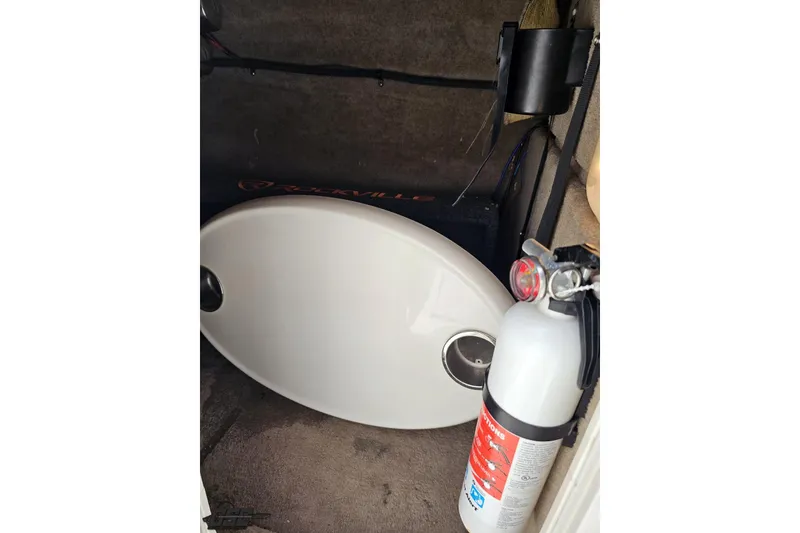 Slide: The Image of Storage compartment of 2007 Chaparral 256 SSi with fire extinguisher and equipment. - 68