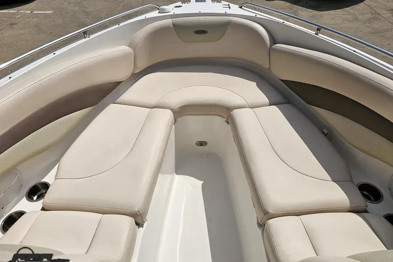 Slide: The Image of 2007 Chaparral 256 SSi boat interior with beige seating and cup holders. - 70
