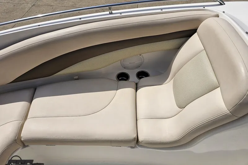 Slide: The Image of 2007 Chaparral 256 SSi boat interior with beige leather seating and cup holders. - 71