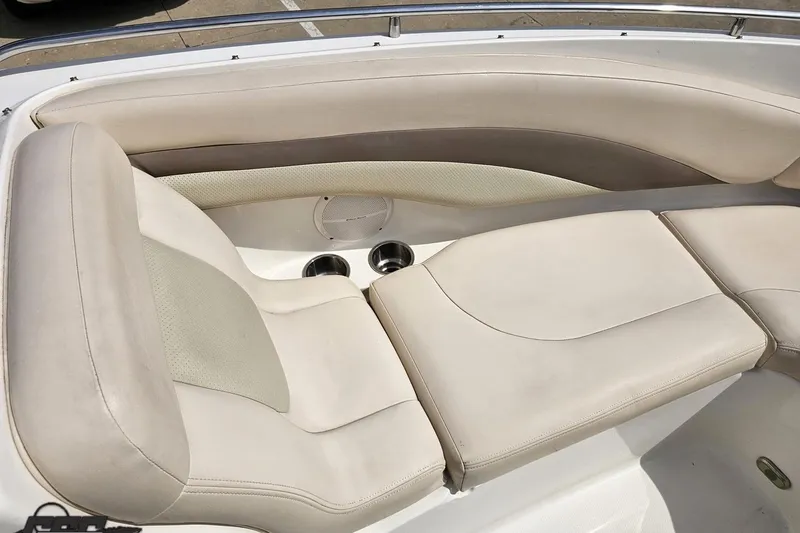 Slide: The Image of 2007 Chaparral 256 SSi boat interior with beige seating and cup holders. - 73
