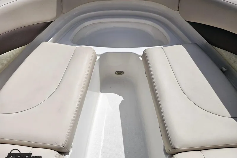 Slide: The Image of Interior seating of 2007 Chaparral 256 SSi boat, featuring beige cushions and sleek design. - 74